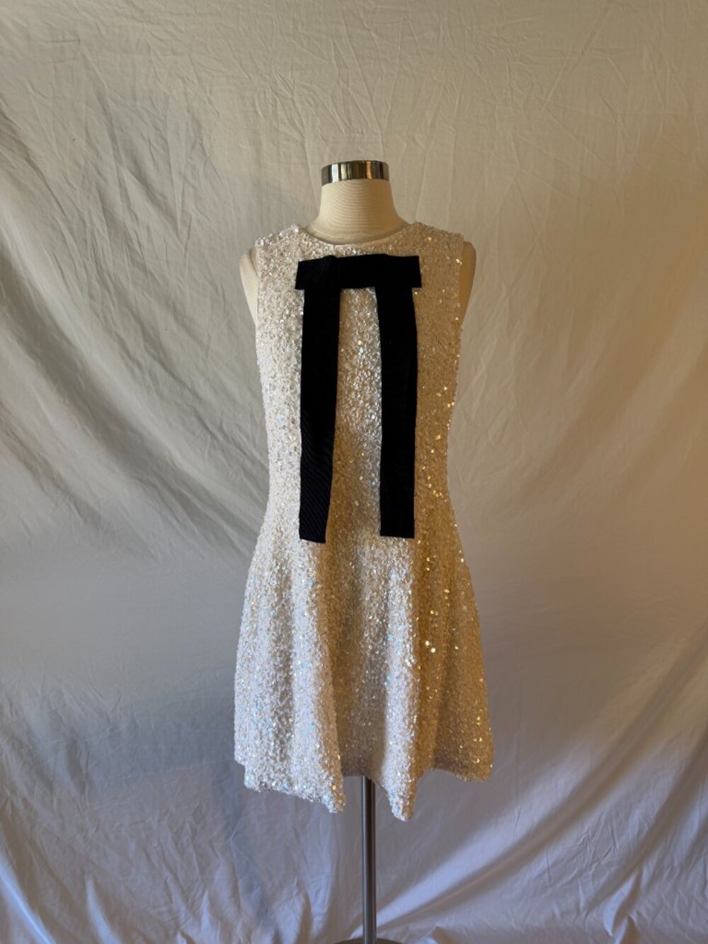 a loves a White Sequin Dress with Black Bow